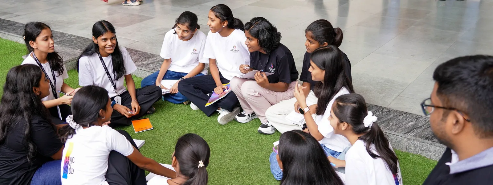 Students in a circle on the grass