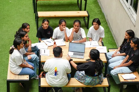 Students talking with two adults