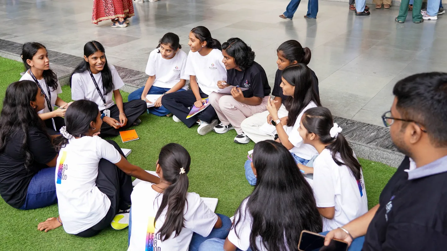 Students in a circle on the grass